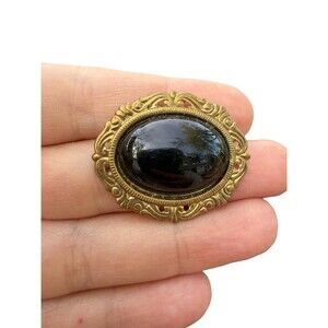 Victorian brooch with black stone black and gold tone pin